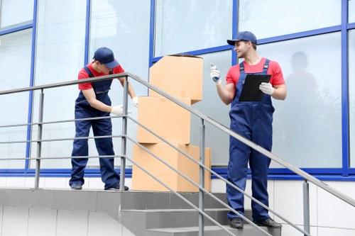 Student removals team working near modern Canary Wharf apartments