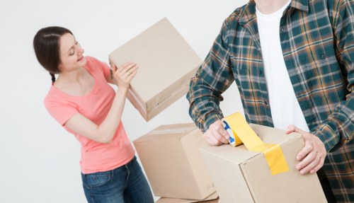 Organised house removals process in Canary Wharf with boxes and equipment