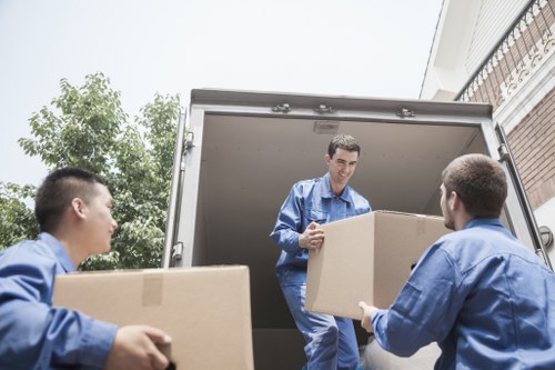 Moving team coordinating logistics in a modern Canary Wharf property