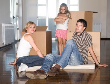 Removal team handling furniture in a modern Canary Wharf building